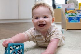 Infant playing with sensory toy in New Horizon Academy's infant childcare program